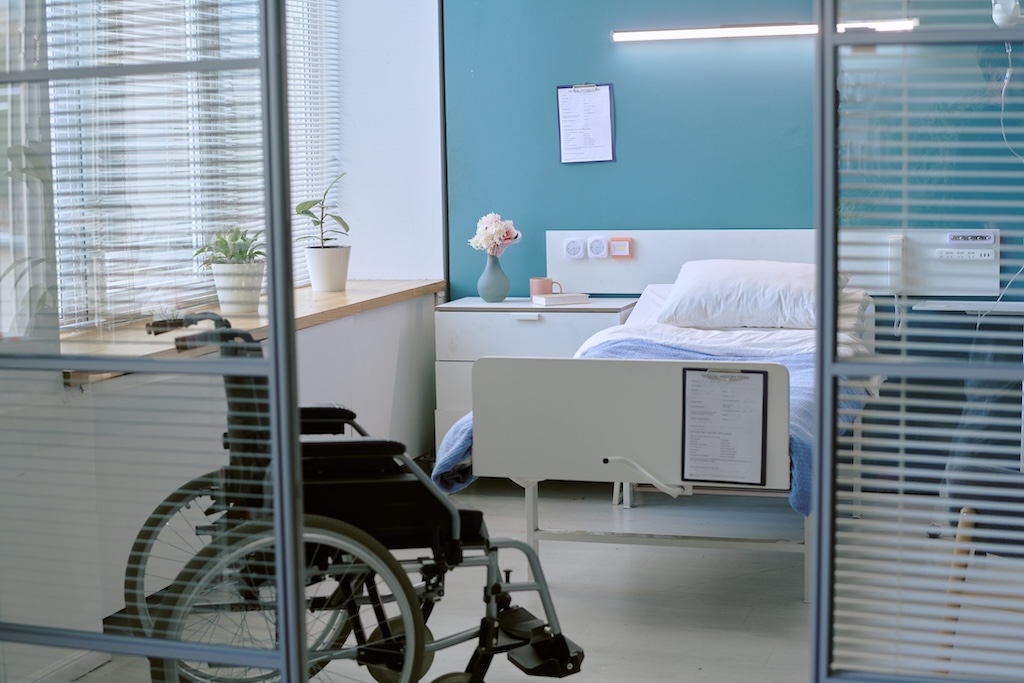 Empty Hospital Room Featuring Wheelchair with Disability near Bed